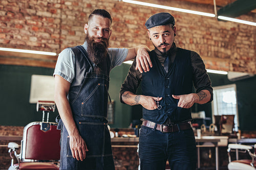 Barber with client standing at barbershop
