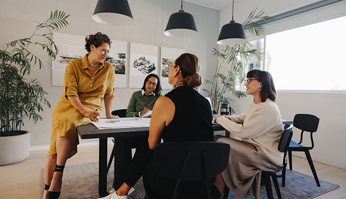 Female team collaborating during a project management session in a modern office