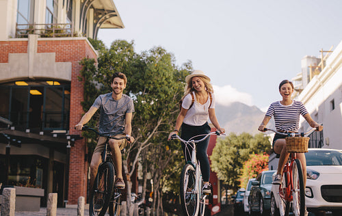 Group of friends cycling in the city