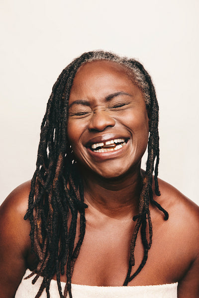 Happy woman taking a capsule of Omega 3 fatty acids