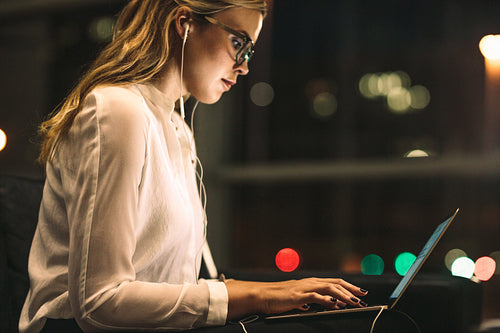 Young woman working late at office