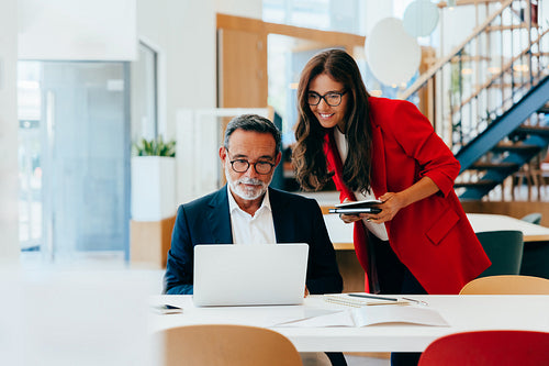 Senior executives engaged in professional discussion at a modern office environment