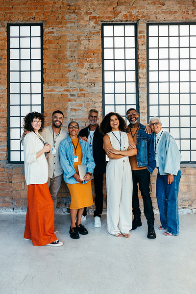Diverse group of smart-casual business managers interacting in a modern office setting
