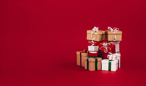 Gift boxes piled up on a red background