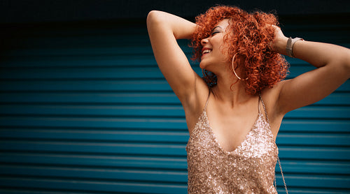 Portrait of a happy young woman in glamorous dress.