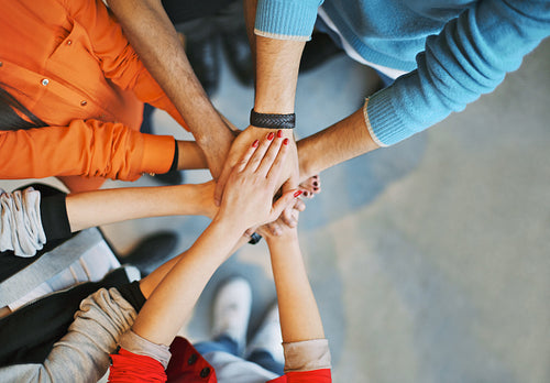 Group Of young people stacking their hands