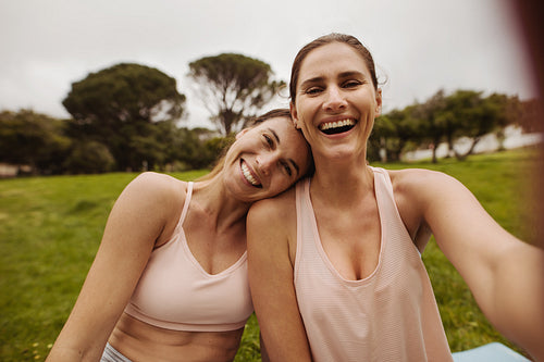 Best friends having fun sitting in a park