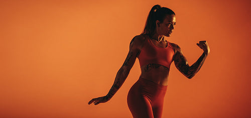 Muscular female showing biceps