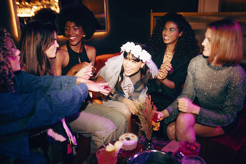 Group of friends celebrating a bachelorette party in a stylish nightclub