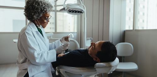 Male patient receives dental consultation in modern clinic