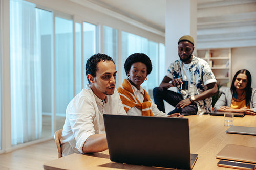Focused team in a modern office engaged in a discussion about a strategic marketing plan