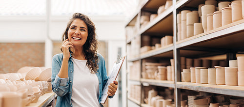 Happy female ceramist thinking of new creative ideas