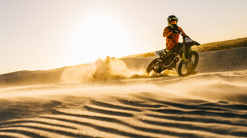 Fast dirt biking in sand dunes
