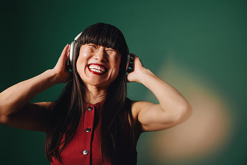 Joyful moments: Embracing music with headphones and a smile