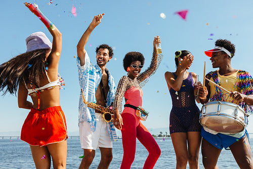 Friends celebrate at the beach party with music