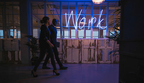 Business executive walking through office corridor