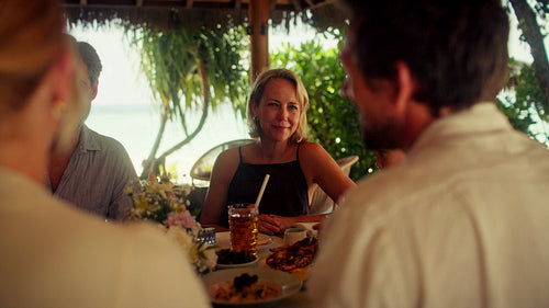 A happy family enjoying a delightful morning meal together at a beautiful tropical resort
