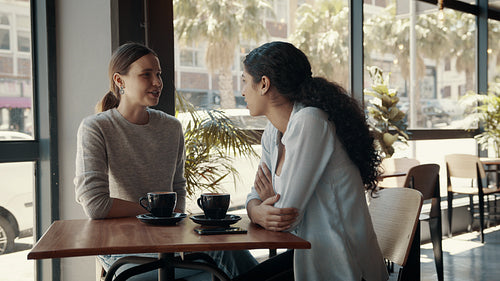 Friends chatting at a coffee shop
