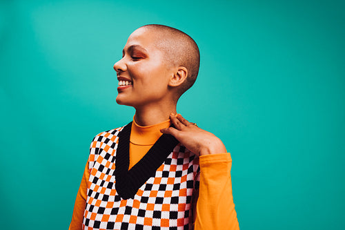 Self-confident woman with short hair smiling in a studio