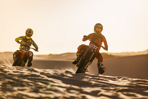 Motocross racers racing in desert