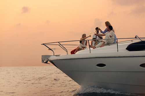 Family toasting on a luxury yacht during a special holiday sunset