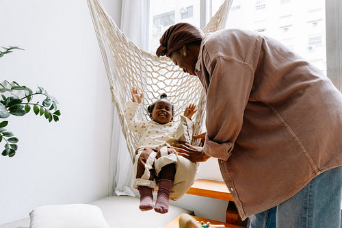 Mother and child in hammock indoors