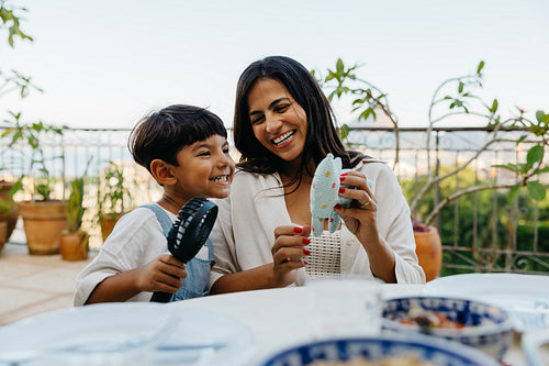 Mother and son enjoying outdoor activities and toys during casual daytime gathering