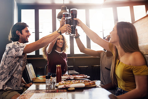 Group of friends making a toast at restaurant