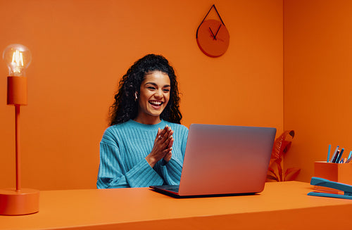 Tech recruiter woman clapping while using laptop in bright, wireless workspace