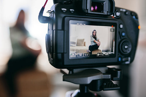 Closeup of a DSLR camera recording a video blog.