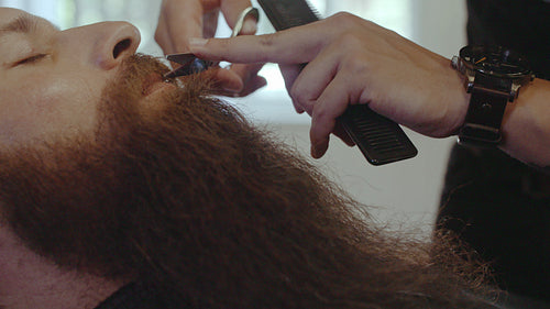 Client getting mustache trimmed at salon