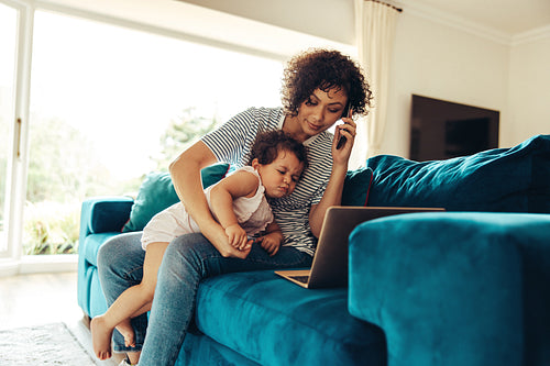 Working mom with baby talking on phone