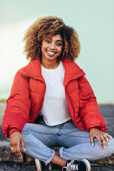 Tourist woman sitting on pavement