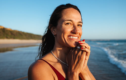 Smiling woman enjoying a sunny beach day in a relaxed and happy mood