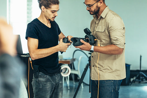 Photographer replacing the lens on his camera during a photo shoot