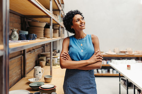 Happy young potter thinking of new creative ideas