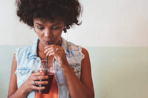 African woman drinking a refreshing beverage