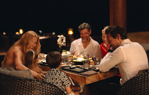 Family enjoying a dinner together at a fine dining restaurant setting