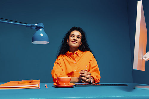 Student thinking in minimalist color blocking office desk