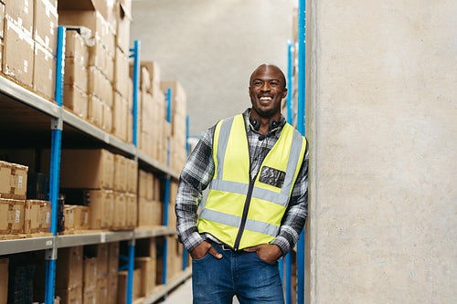 Happy warehouse order picker smiling at the camera