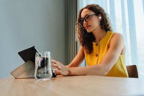 Woman using a tablet during a digital work session indoors