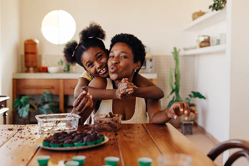 Mom and daughter family making Brazilian brigadeiro for dessert