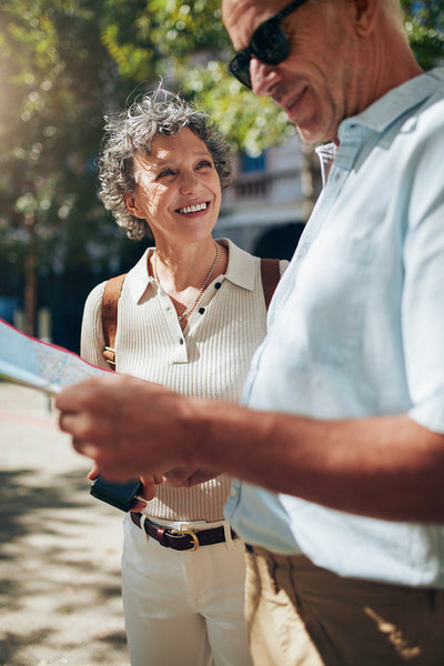 Mature couple using map on vacation