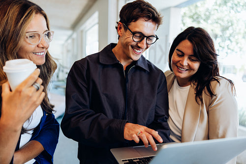 Colleagues collaborating on business project showing teamwork