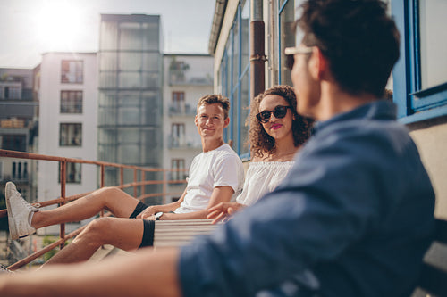 Group of young people relaxing in a balcony