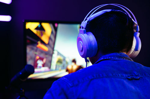 Computer gamer live streaming his video gameplay on an online platform