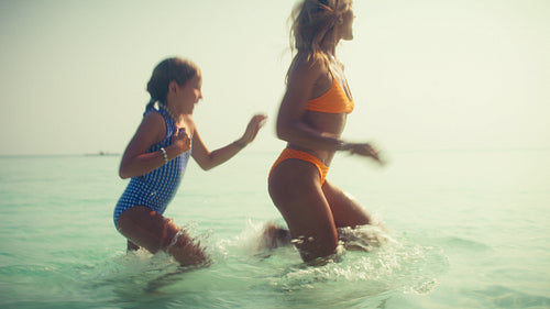Joyful mother and daughter enjoy an idyllic tropical family vacation at a luxurious resort
