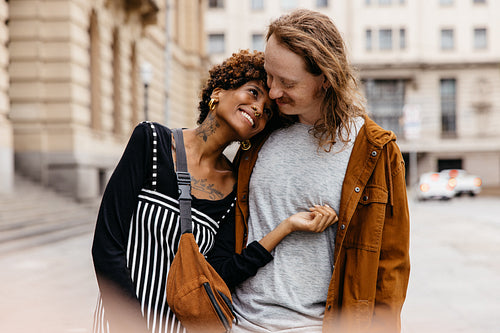 Affectionate embrace on a city stroll, couple enjoying togetherness