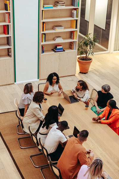 Top-view of a colorful team meeting in a modern office space