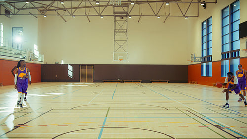 Young man playing basketball in gym